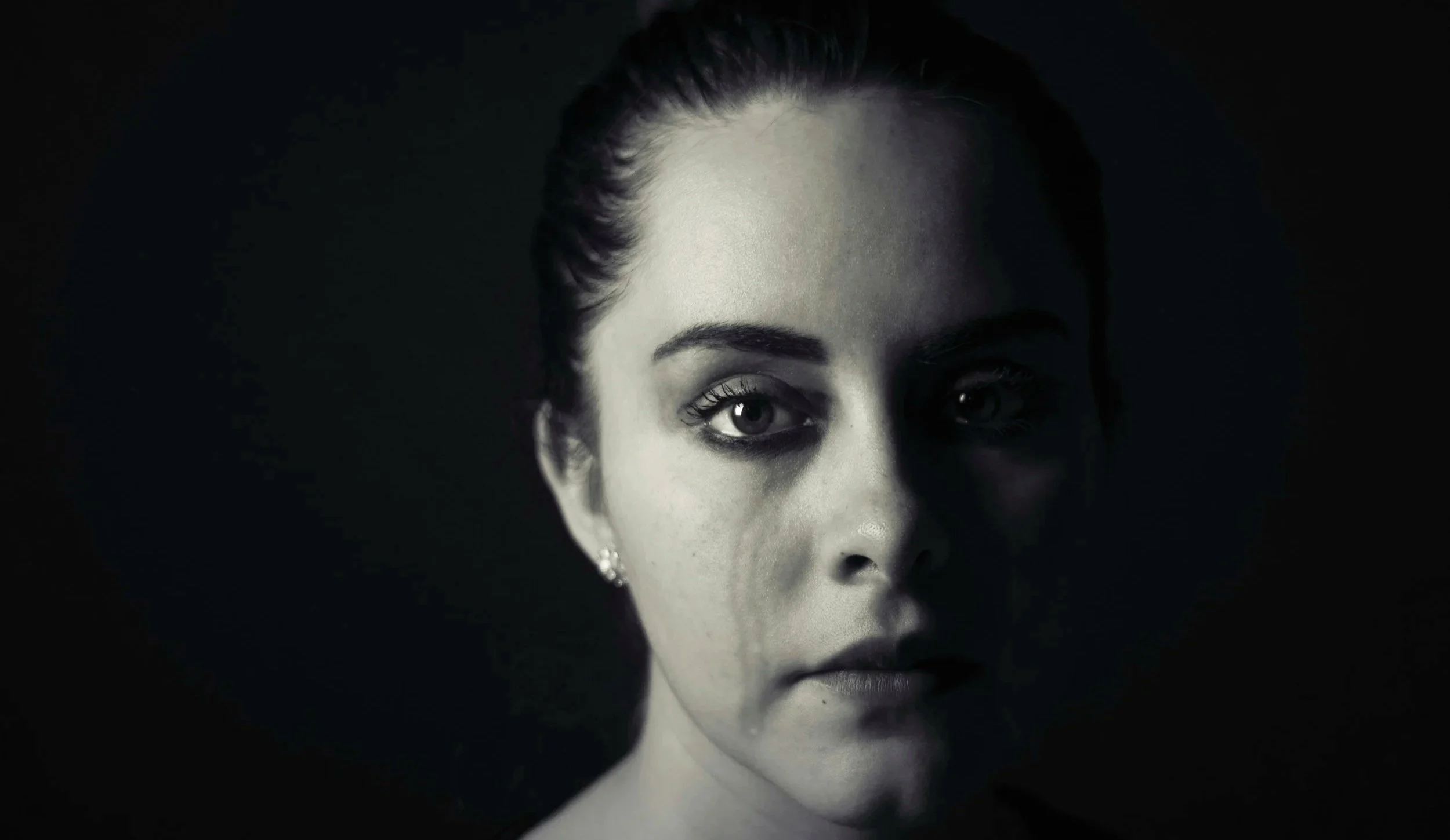 Adult experiencing emotional overwhelm and frequent crying related to trauma, chronic stress, and nervous system dysregulation