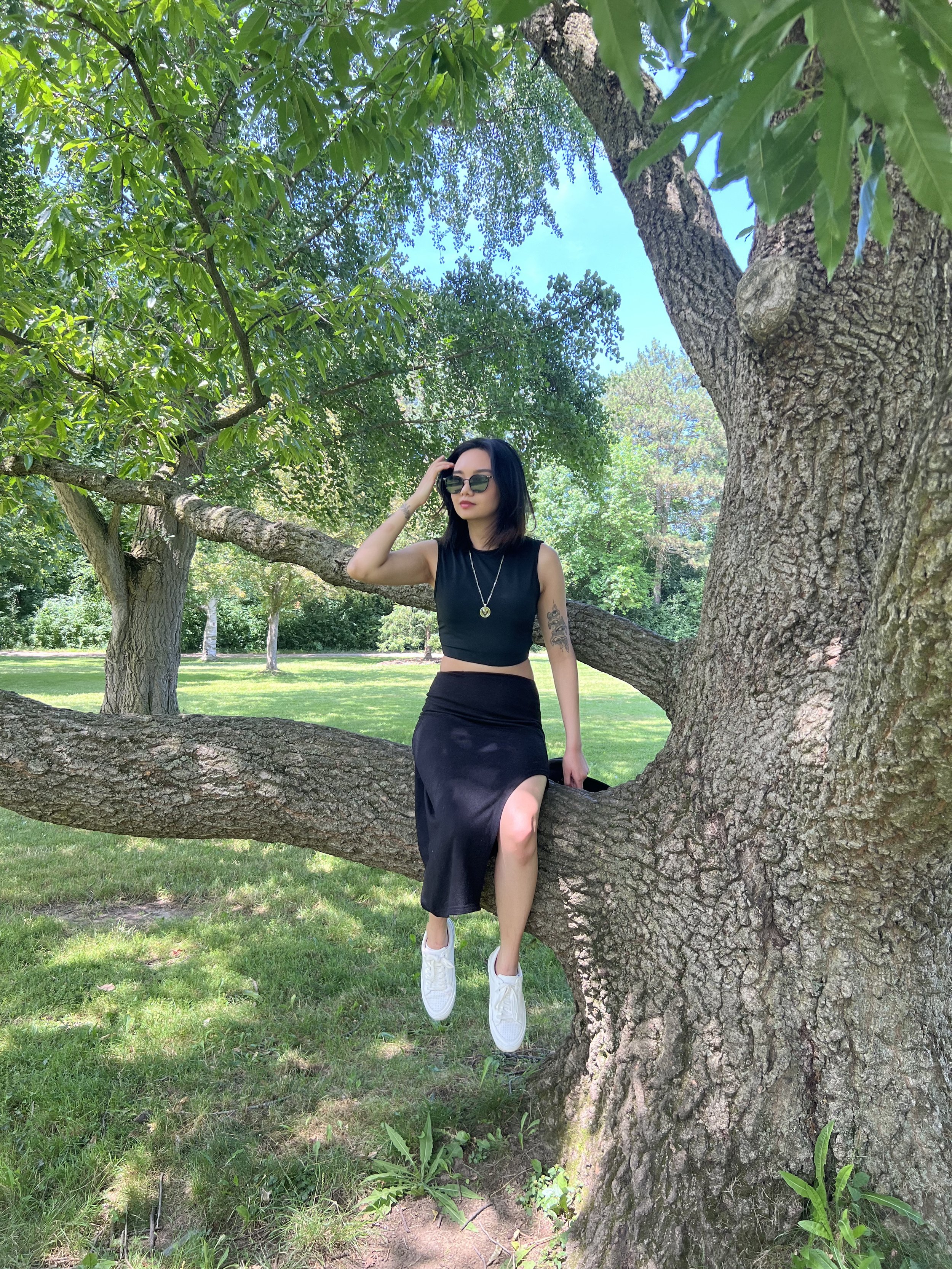 Bernice Santos, Canadian writer, editor and copywriter, outdoors in a park.