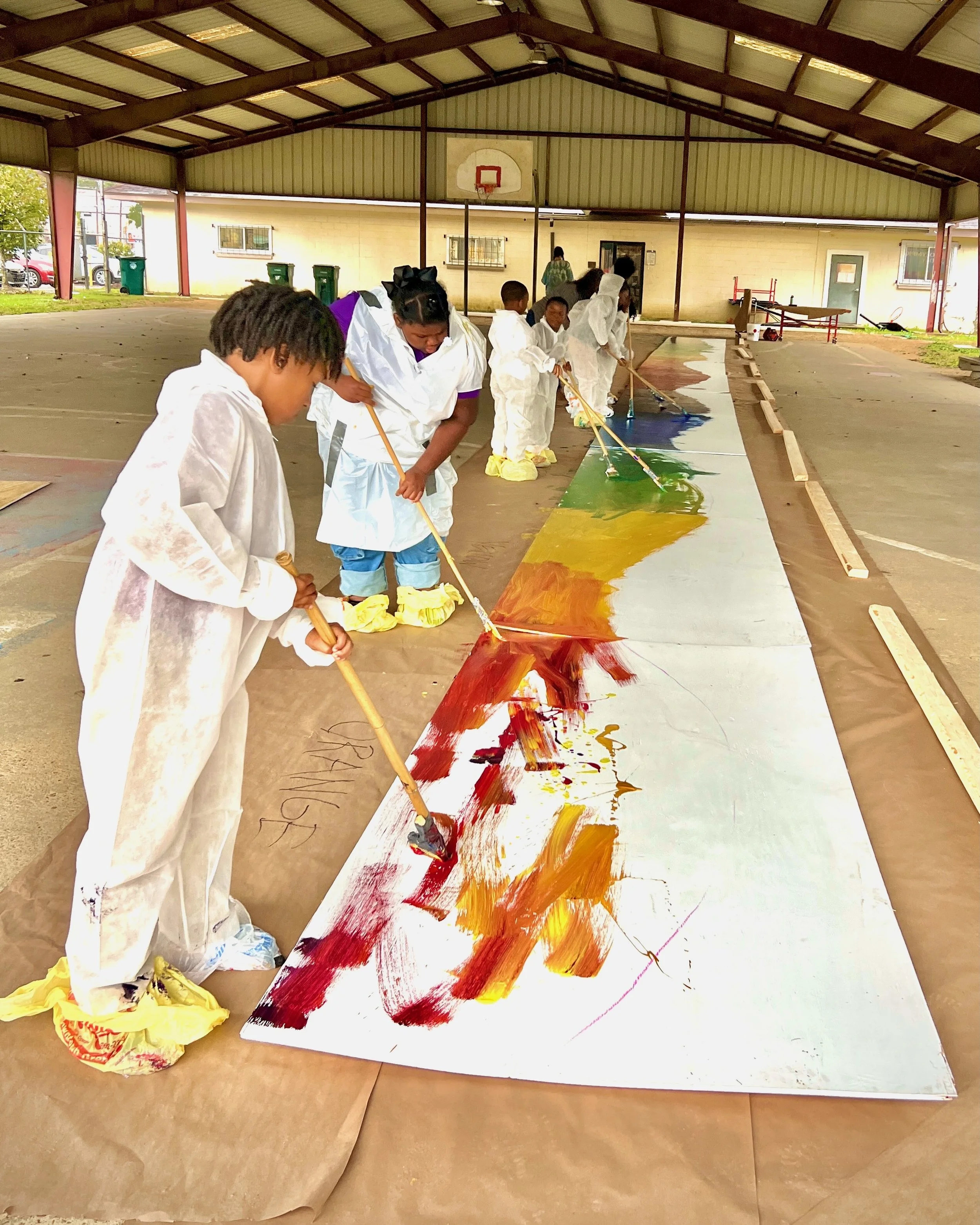 Club members participate in the mural painting process