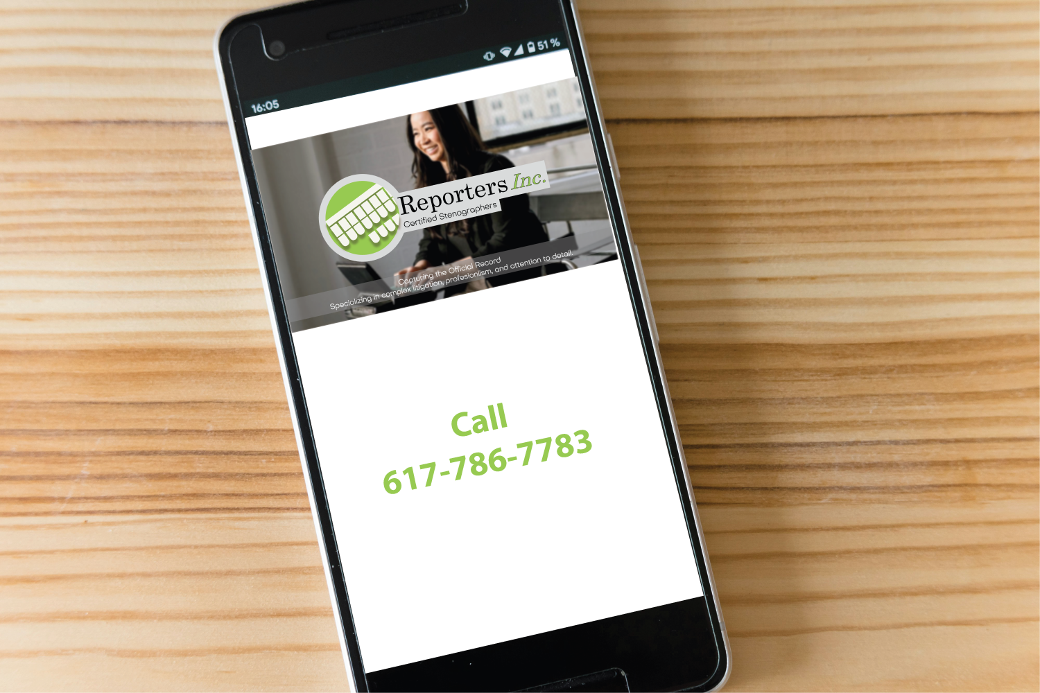 Image of cellphone on a wood background. Shown on cellphone is an image of stenographer smiling with the Reporters, Inc. logo and below reads, call 617-786-7783