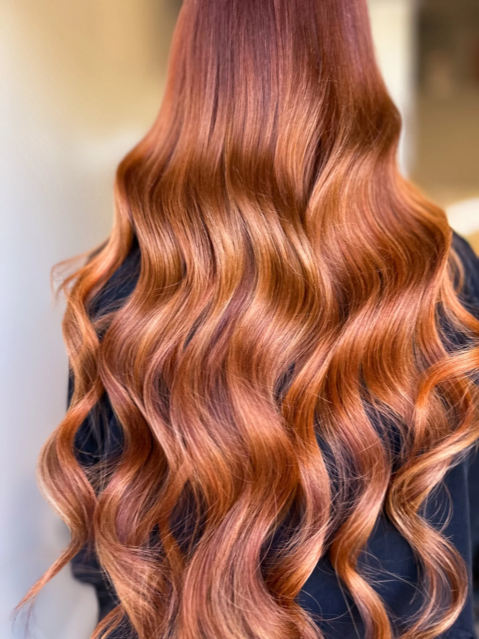Close-up of long, wavy, reddish-brown hair.