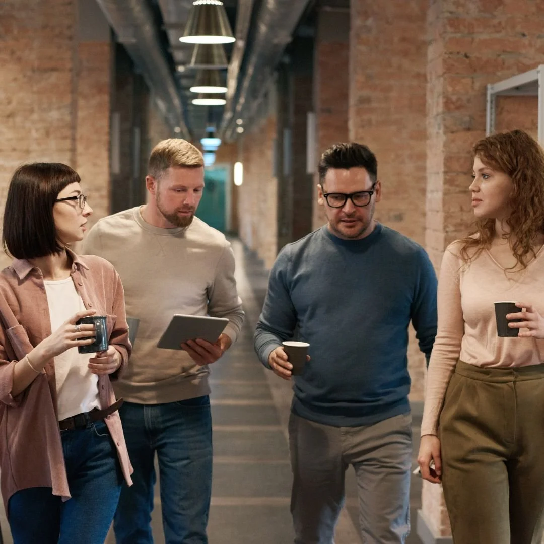 4 Co-Workers Walking Together