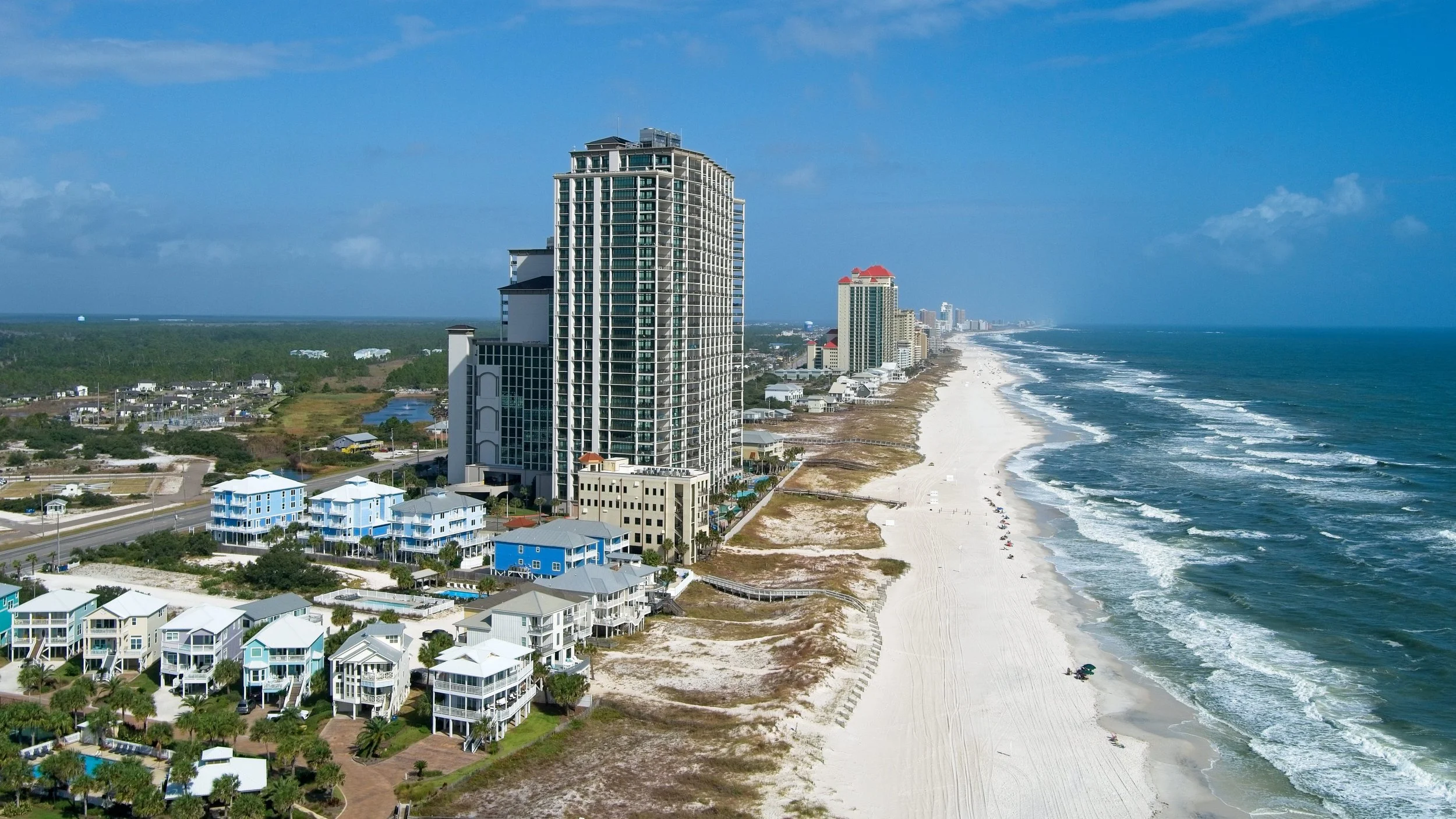Aerial view of Gulf-front condo towers, beach homes and the shoreline