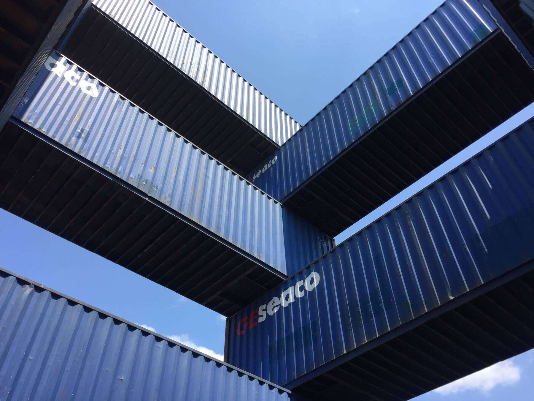 Stack of blue shipping containers. 