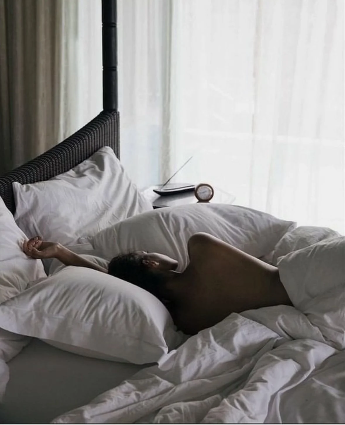 woman exhusted from waking up at 3am and can't fall back asleep or waking up multiple times a night