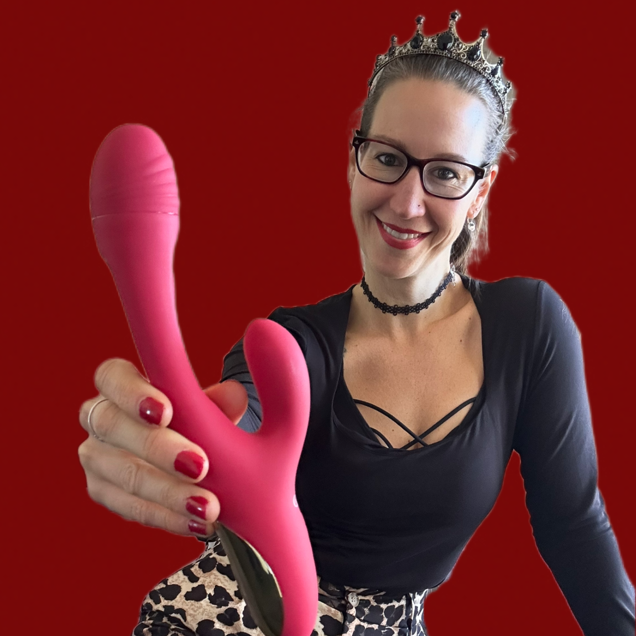 Pleasure Toy Queen Patricia holding the red orion sweet smile rabbit vibrator