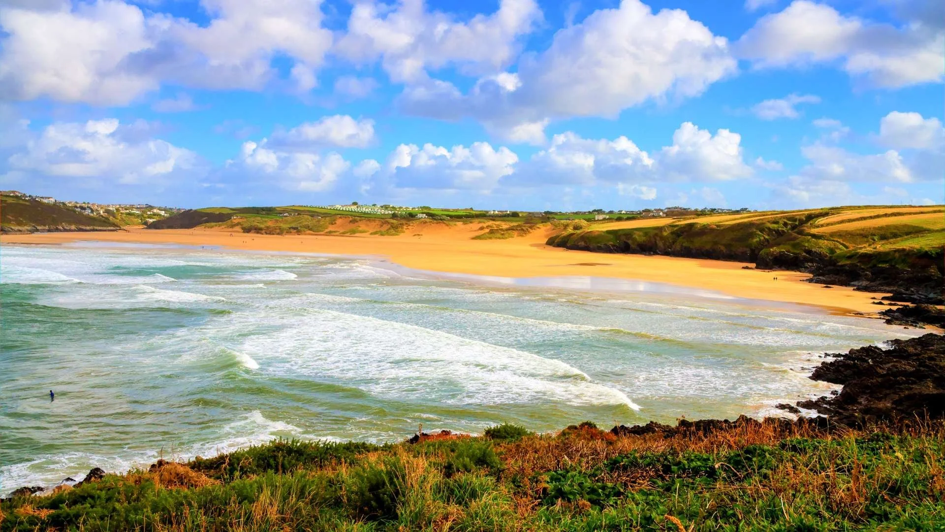 Crantock Beach: "Serene view of Crantock Beach with its expansive sandy shores and gentle waves."