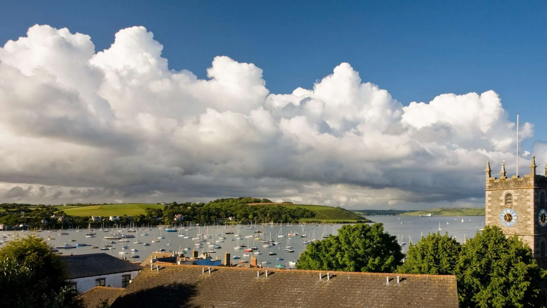 Falmouth: "Harbour view of Falmouth, showcasing boats, the marina, and the vibrant town atmosphere."