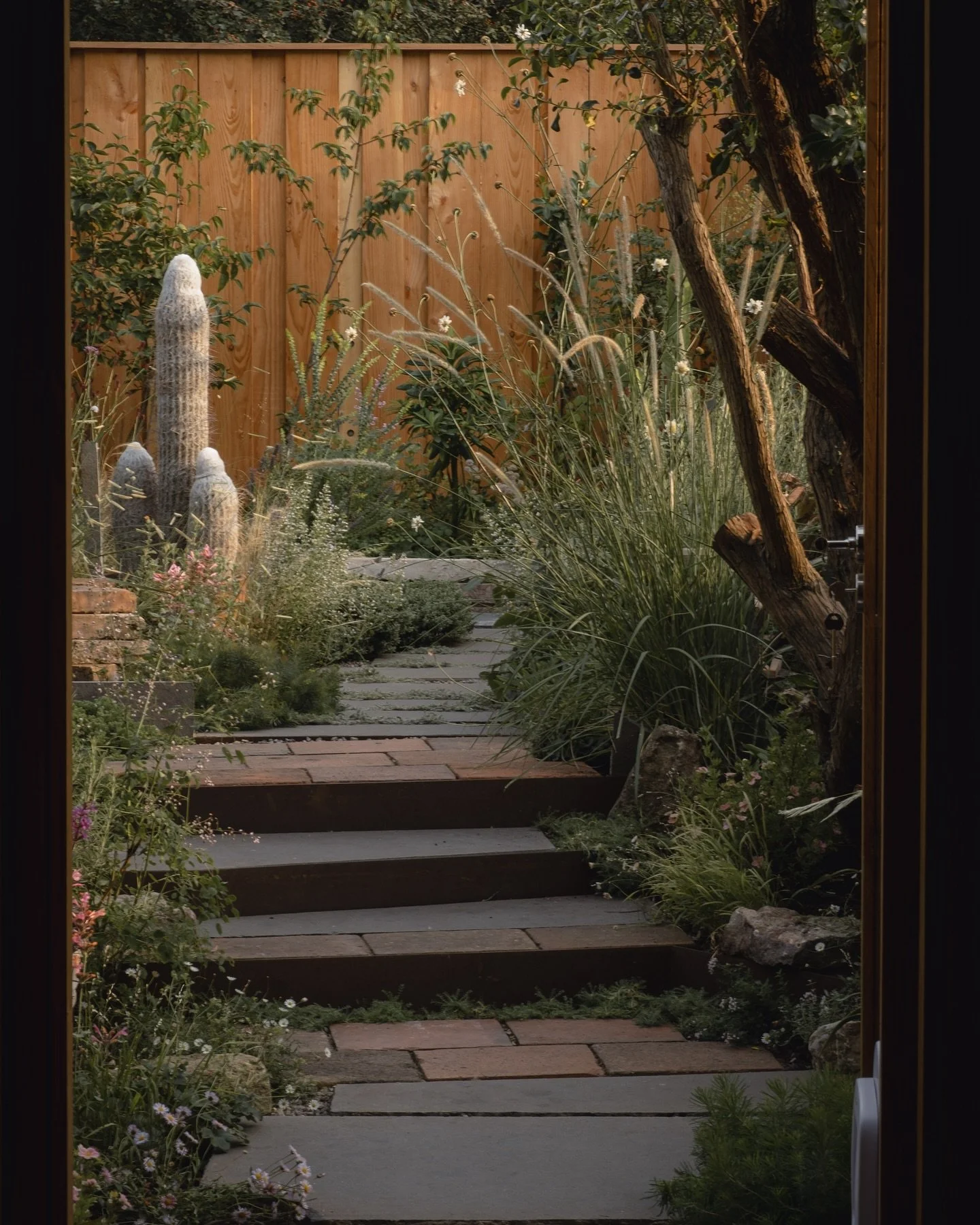 Rustic Victorian terrace garden

The kitchen door lines up with the main glass door and then the garden path. The garden path has a slight kink to it. This layers and fringes the vista with planting and invites the viewer out into the garden to see w