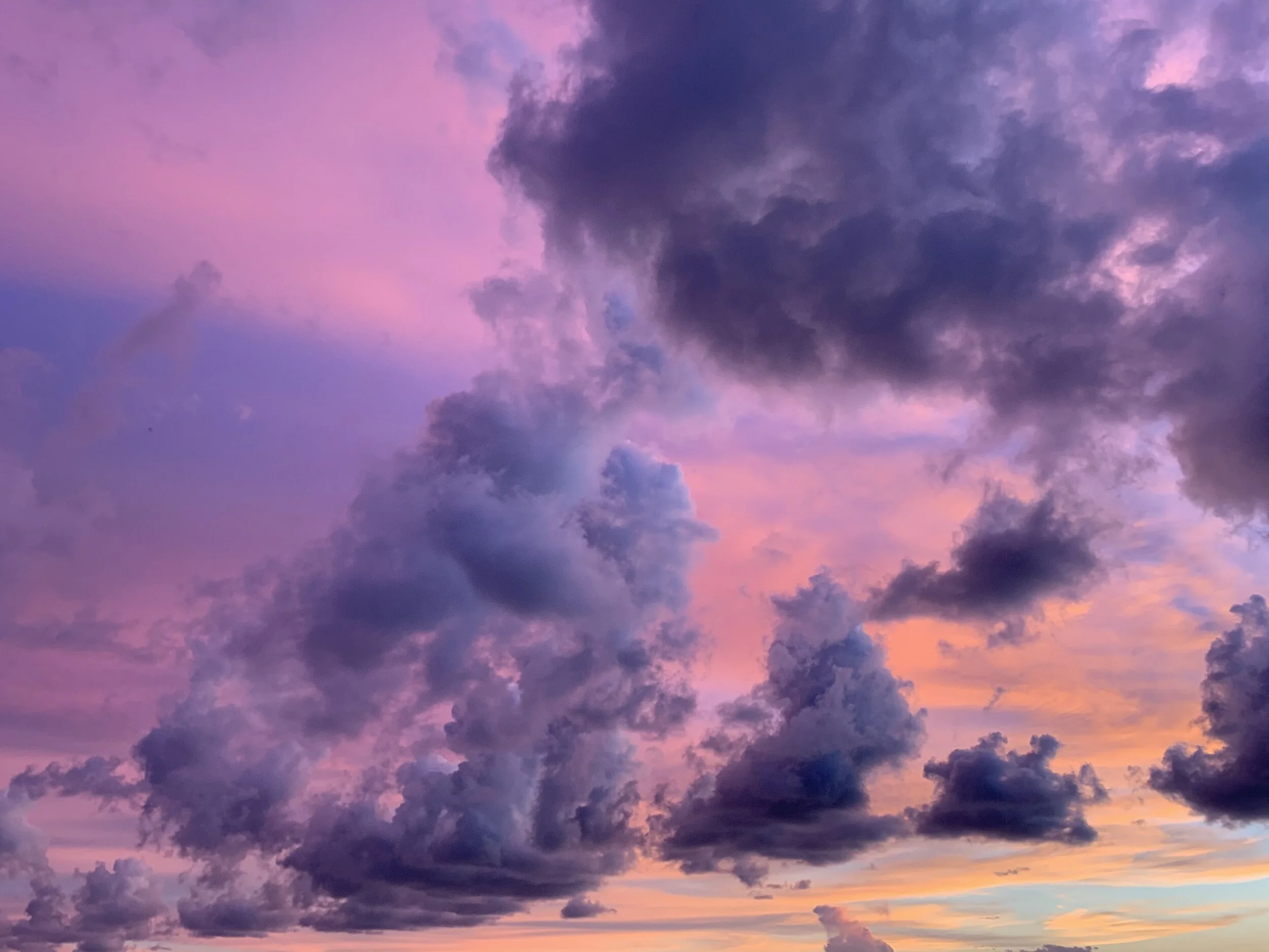Colorful sky with pink, purple, and orange clouds during sunset.