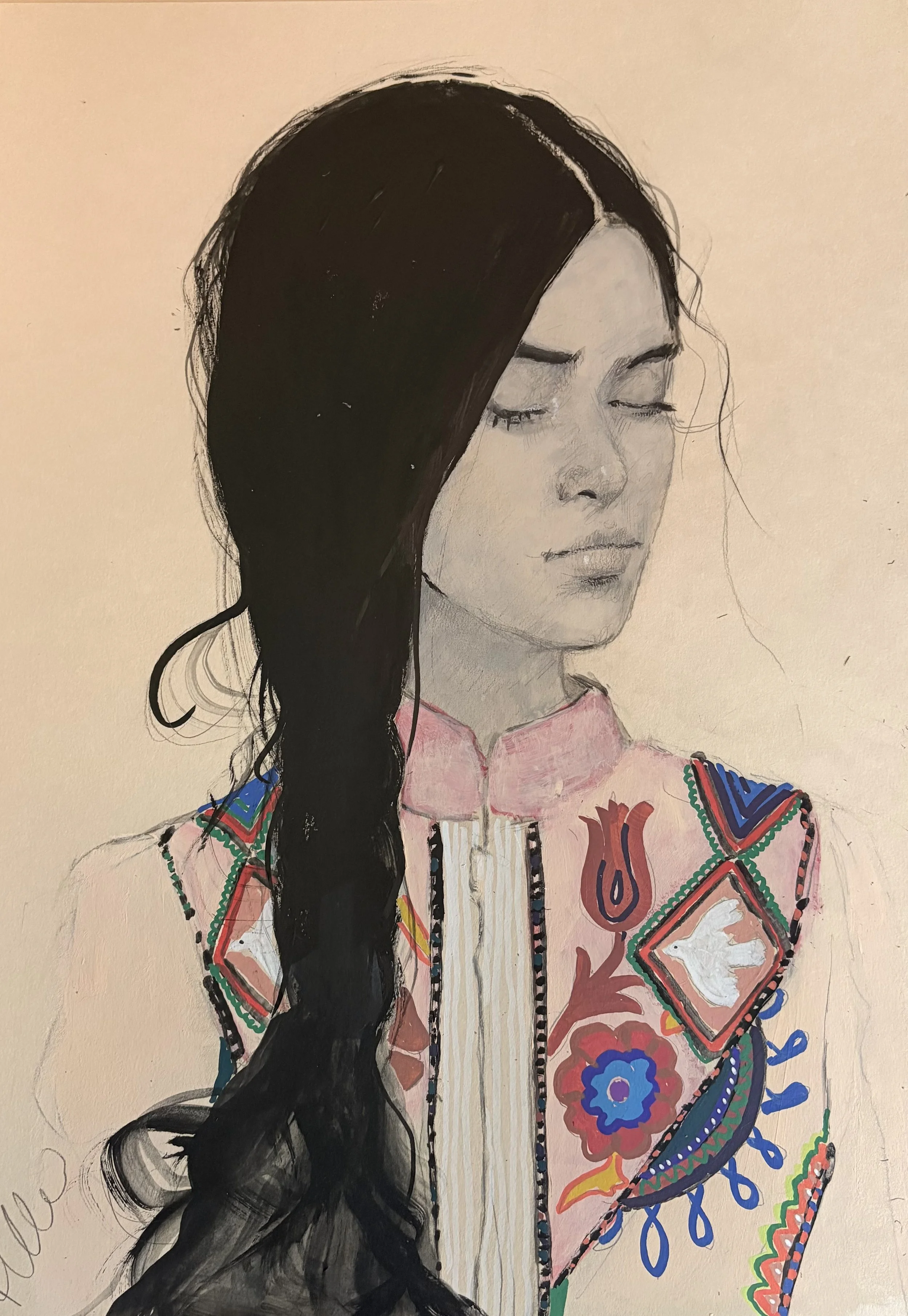 A portrait of a woman with closed eyes, long black hair, wearing a pink top with colorful embroidered patterns.