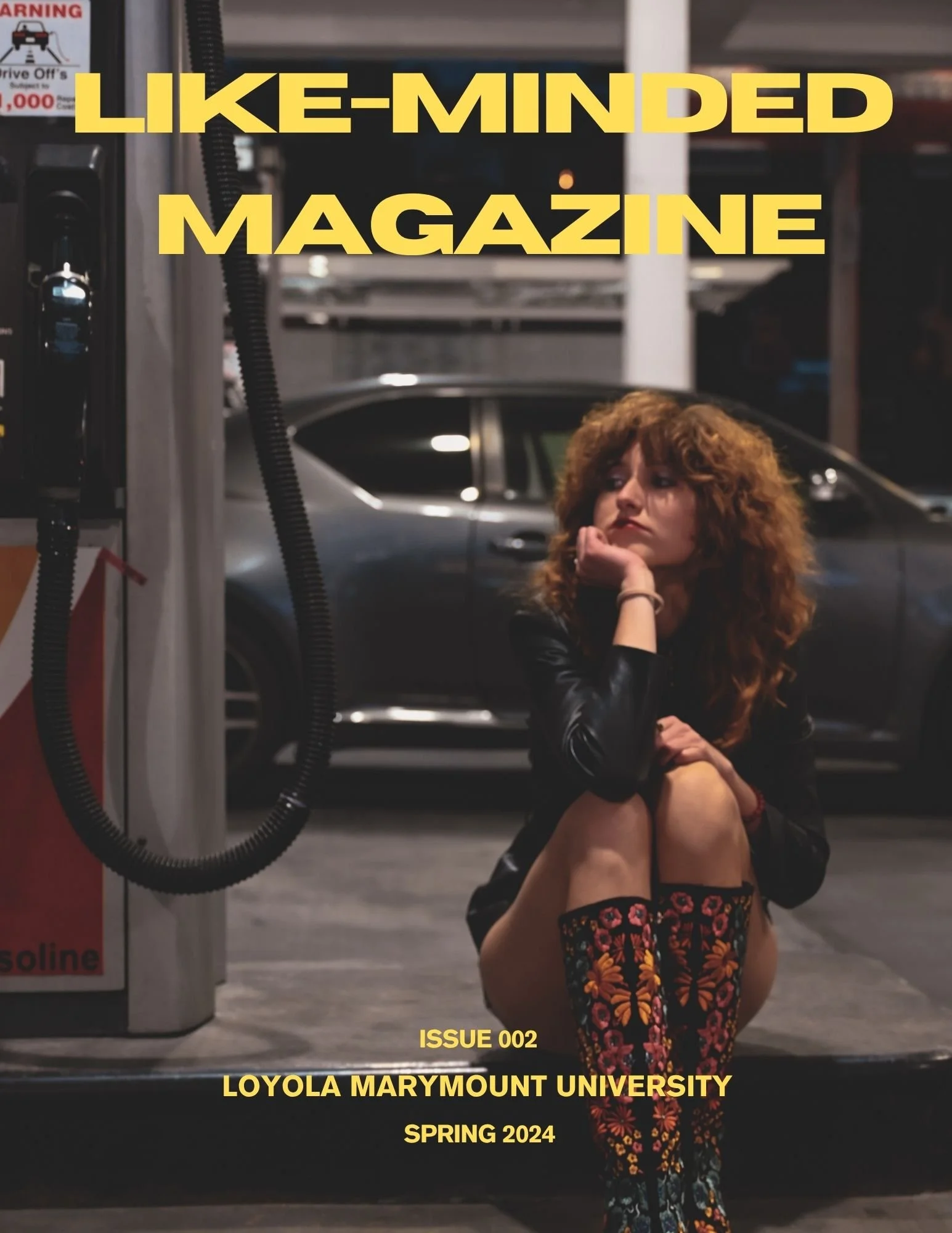 Young woman sitting on the ground in a parking garage, resting her chin on her hand, with a gray car behind her and large yellow text overlay reading 'LIKE-MINDED MAGAZINE', and additional text indicating issue number 002, Loyola Marymount University, Spring 2024.
