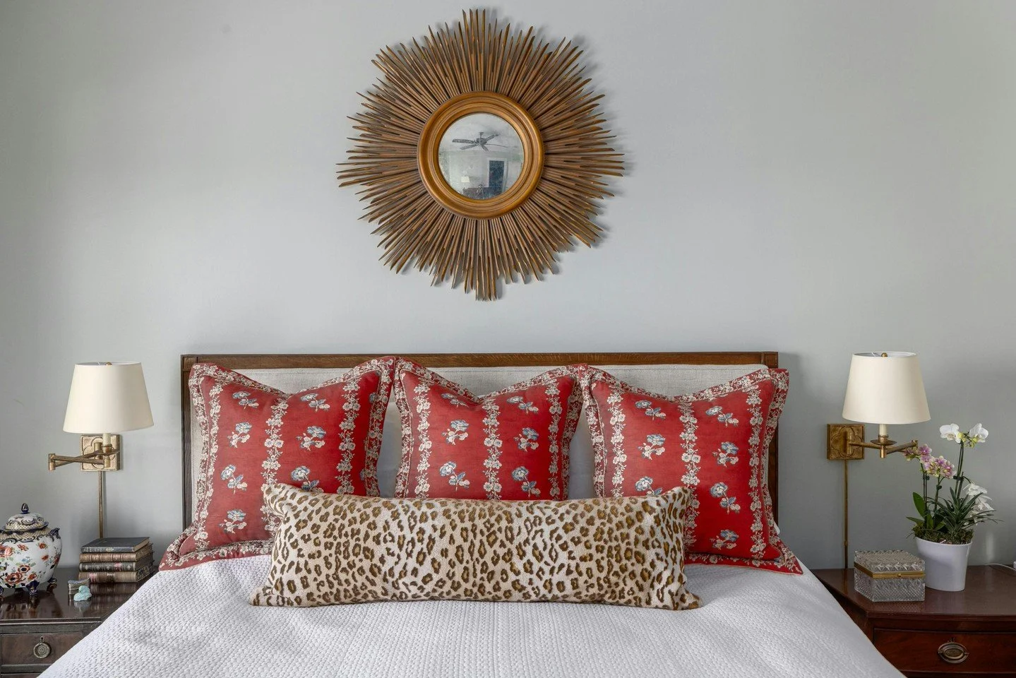 Rich color, collected patterns, and a gilded sunburst mirror bring depth to this bedroom palette. 

#InteriorDesign #LuxuryInteriors #BedroomDesign #PrimaryBedroomStyle #DesignInspiration #HomeInspo #CarolineBrackettDesign