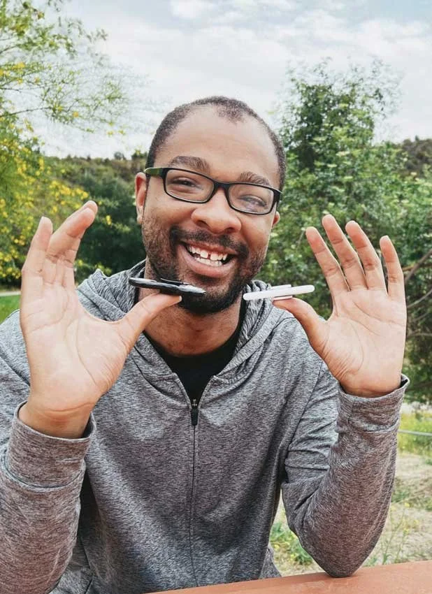 A man smiling outdoors, during Adaptive Skills training for adult with autism with Advanced Crisis Solution in California