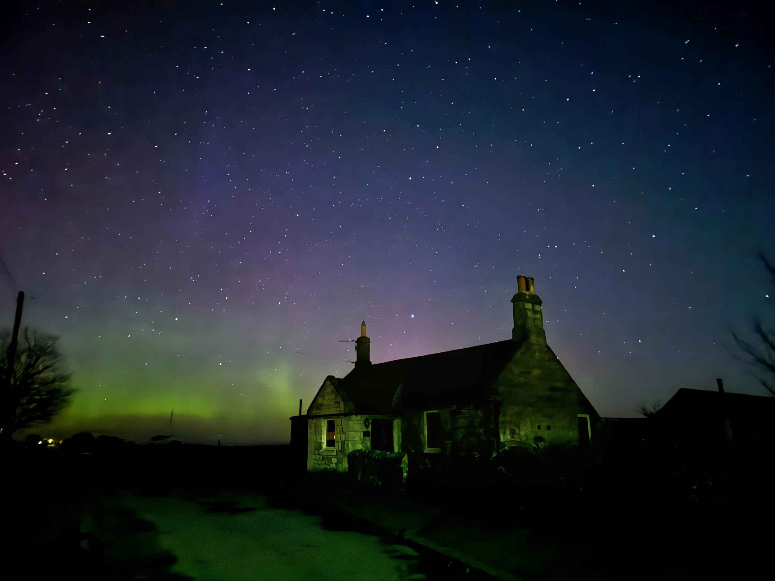 Northern Lights visible above the cottage