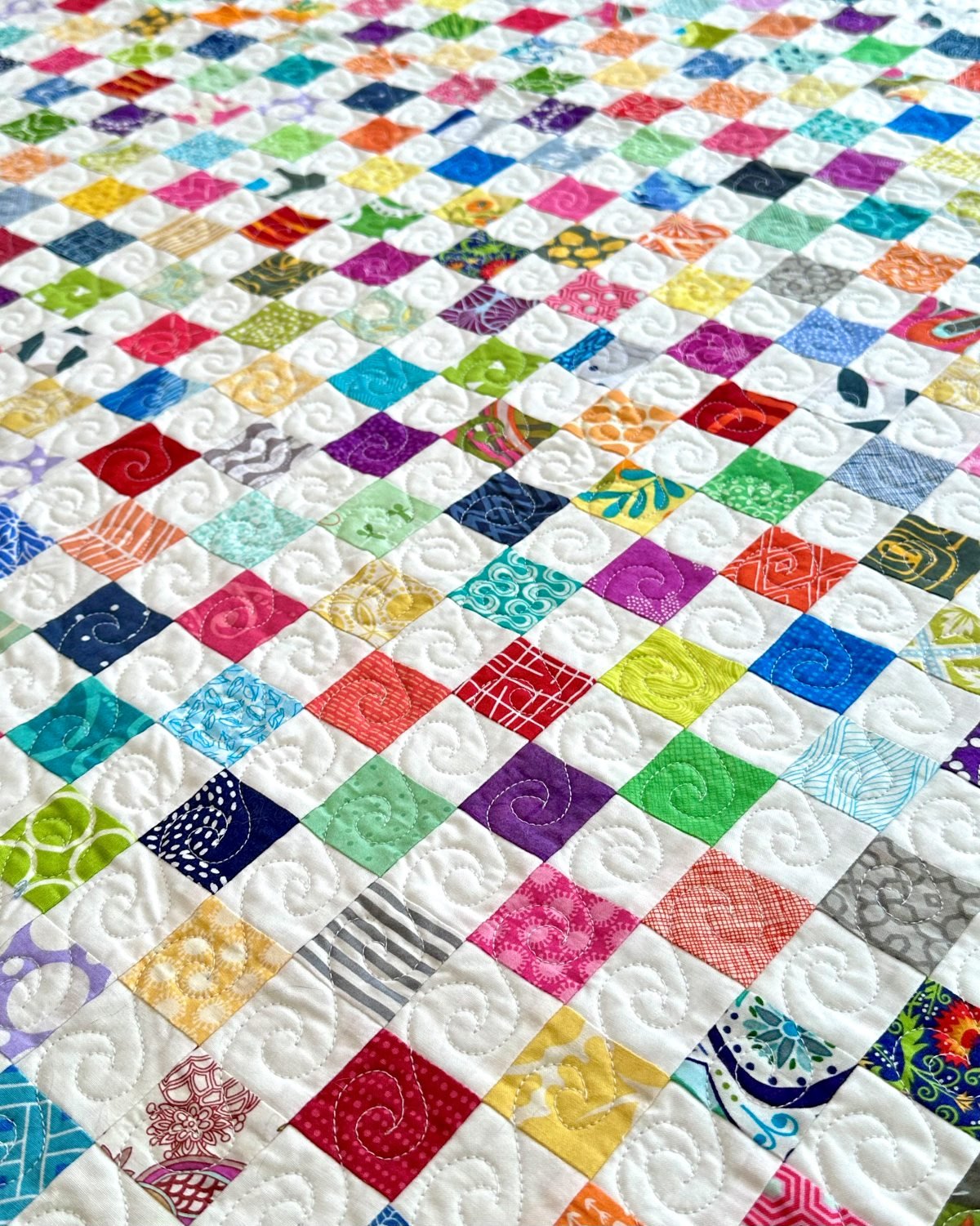 Large scrappy quilt with quilting detail
