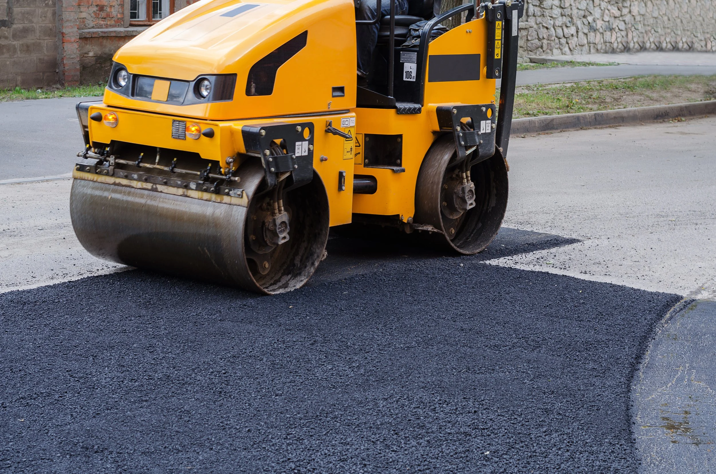 a double drum roller compacting freshly laid asphalt