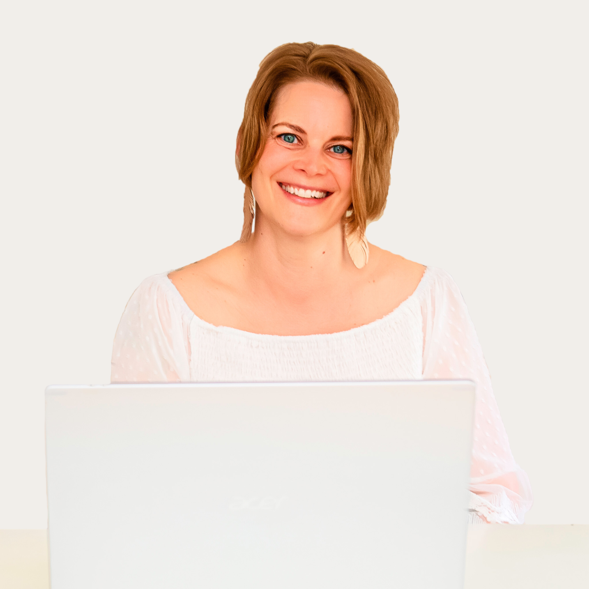 Alt text: Danielle Ratliff of Joyful Rising Writing & Marketing smiling at a laptop, professional headshot of the marketing strategist featured in SouthPark Magazine January 2026.