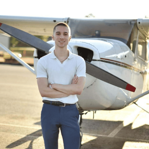 Photo of Konstantin Cornwell, Owner of SkyRise Drone Photography, standing in front of a private plane.