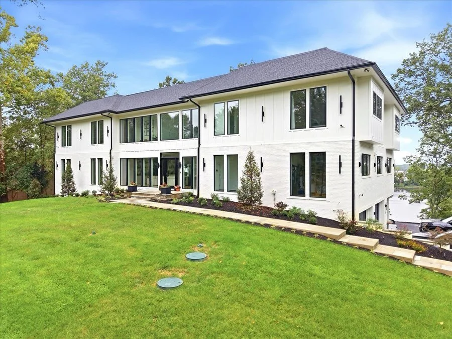 What was once a traditional single-story brick home has been transformed into a modern waterfront residence, thoughtfully designed to maximize space, air, natural light, while framing the surrounding views.

The transformation included a complete int