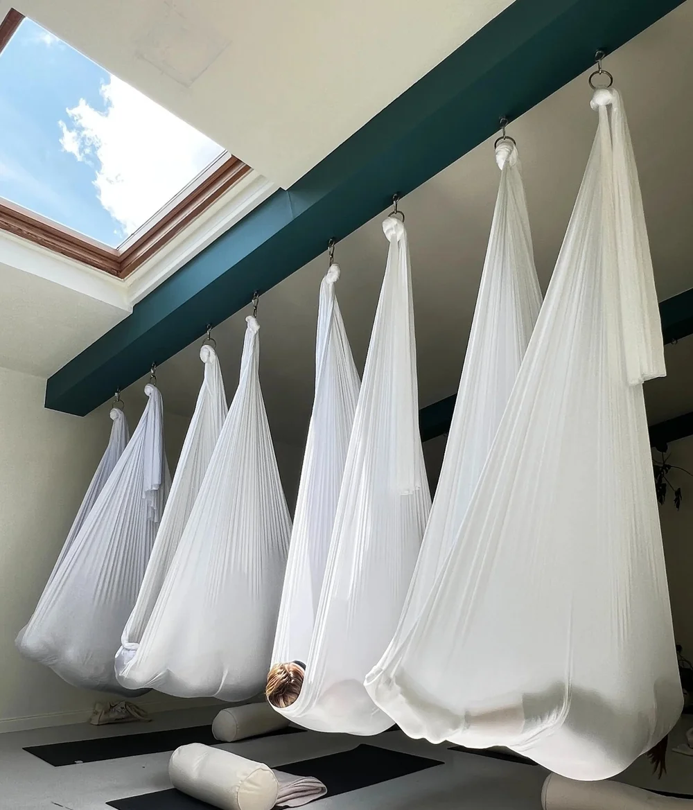 Aerial hammocks rigged beneath the skylight