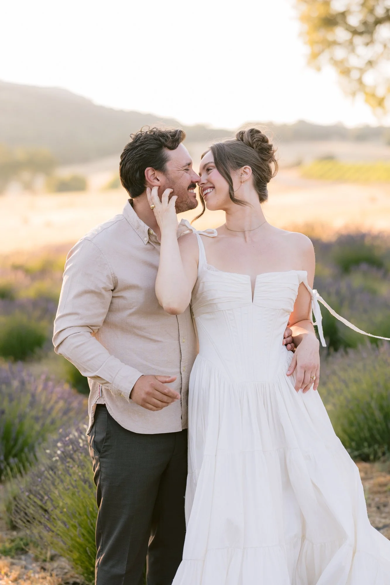 Romantic couple walking through lavender rows at sunset on a Paso Robles farm
