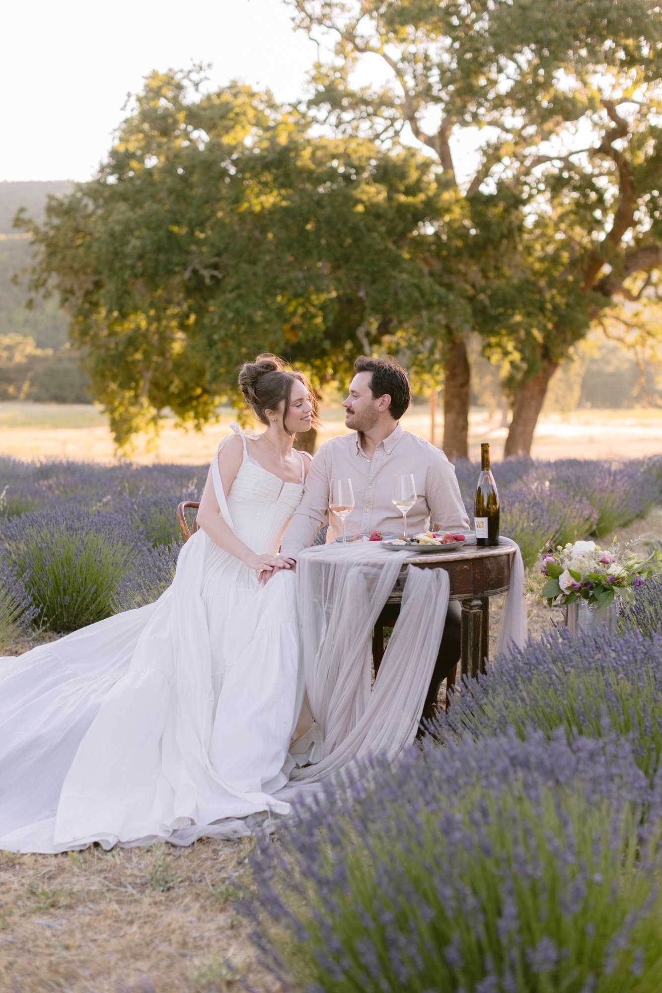 Newlyweds celebrating with champagne on a secluded lavender farm in Paso Robles