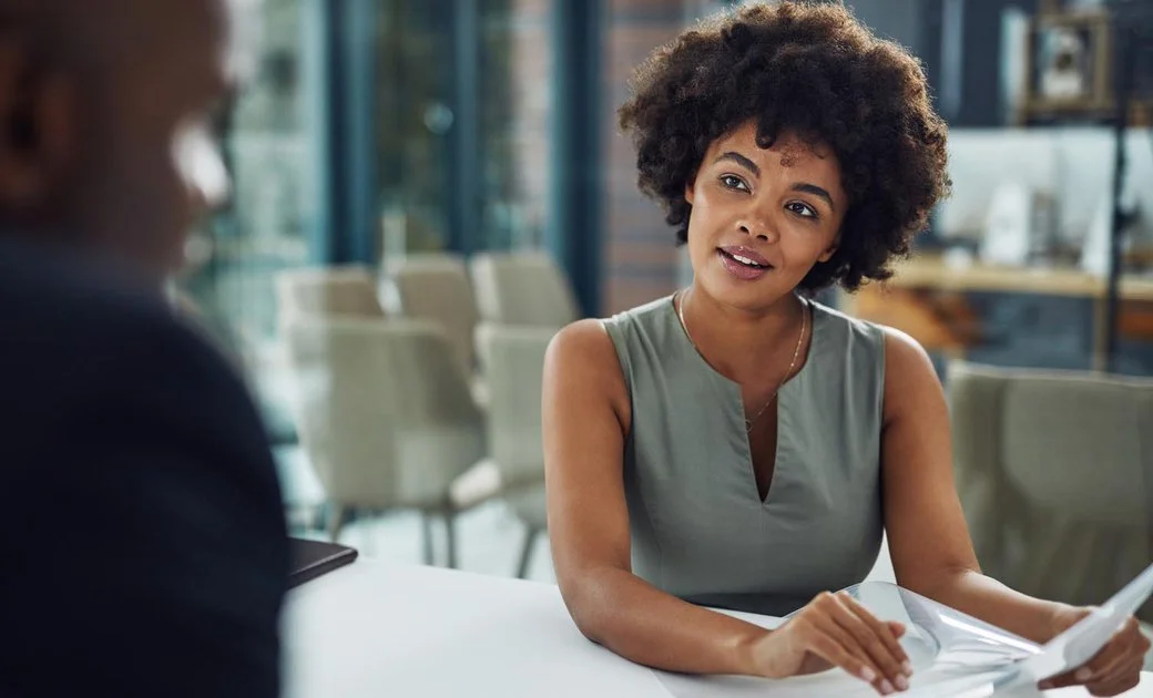 A business woman discussing a project with a coworker