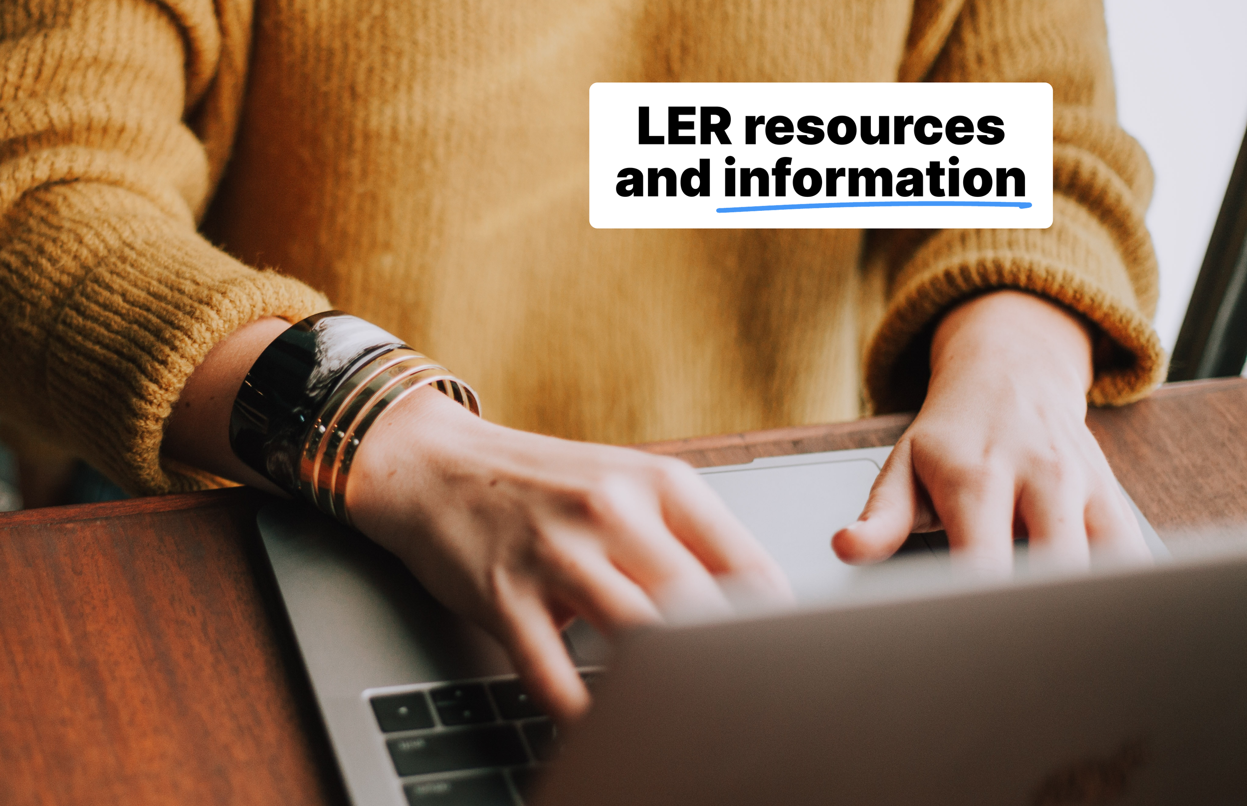 A person's hands on a laptop typing