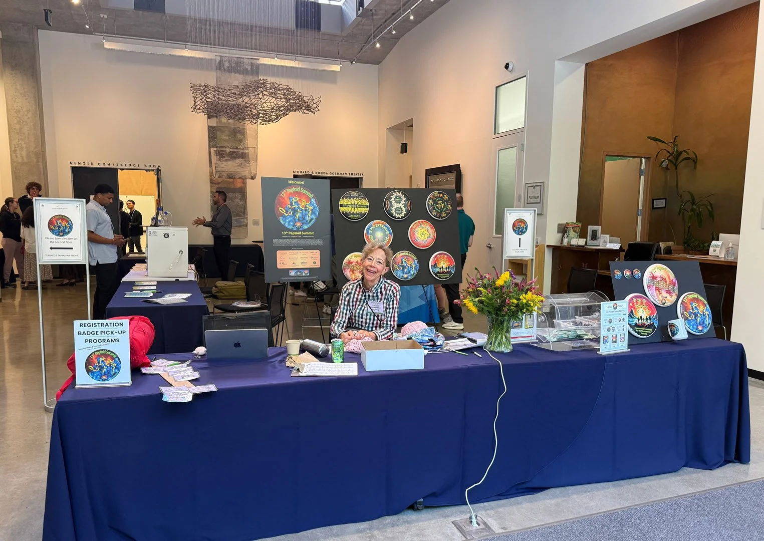 Elizabeth welcoming and registering people
