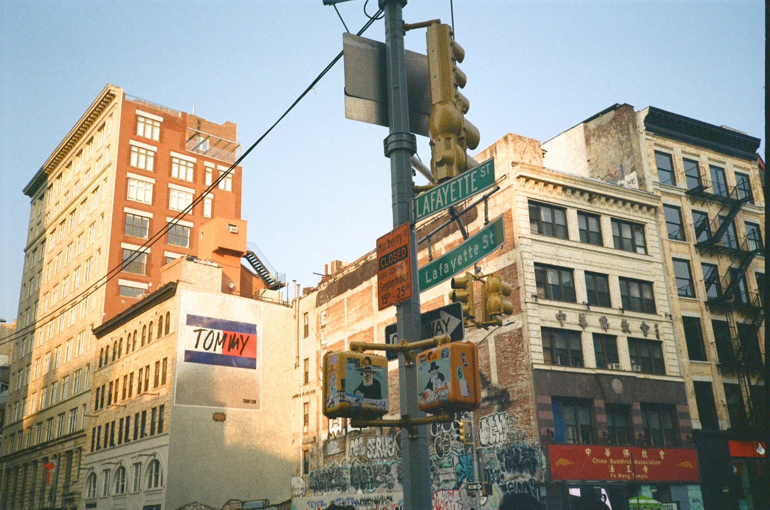 Street scene at Lafayette Street with city buildings, traffic lights, a street sign, and graffiti on the walls.