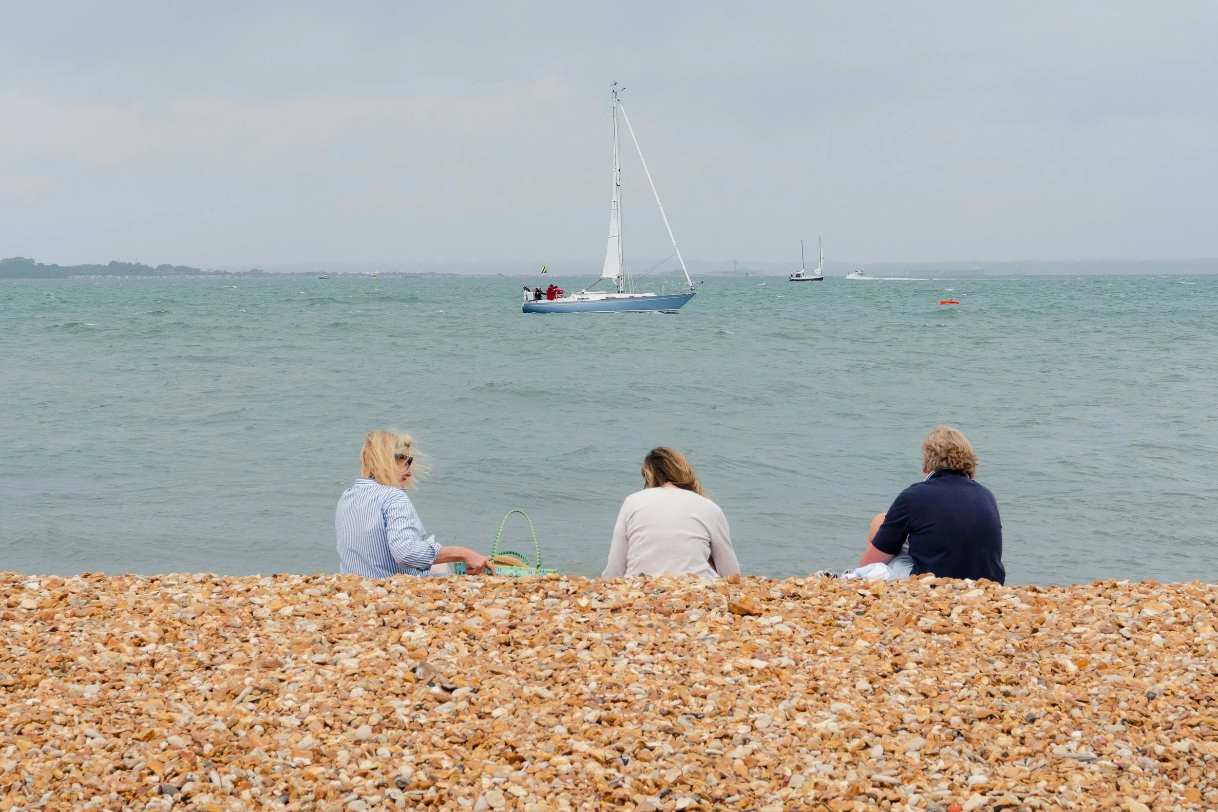 3 women sat on the beach