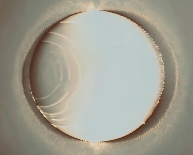Close-up of a metallic pipe opening with a bright, smooth surface reflecting light Astrology, moon, spiritual, ritual, ceremony, priestess