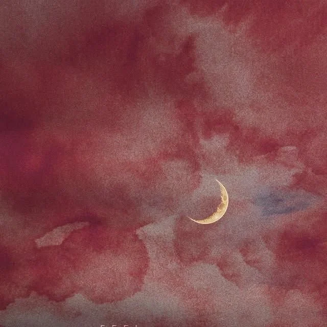 Red and pink clouds in the sky with a crescent moon.