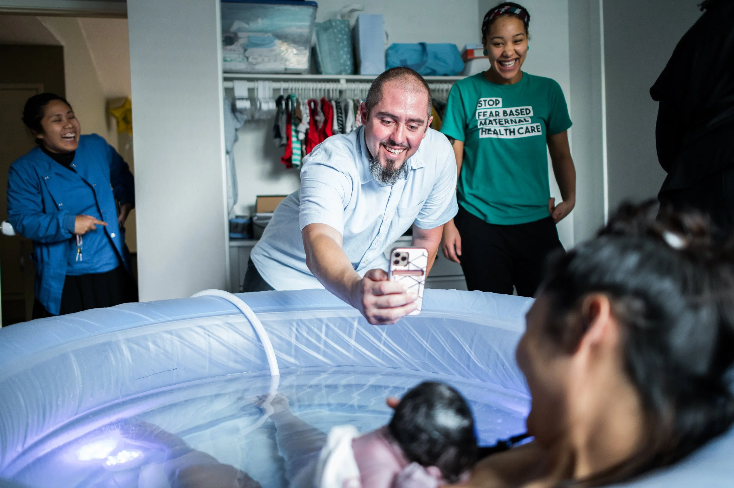 Dad and birth team so happy and excited that mama just had her home water birth and mom and baby are doing well. La Mirada birth photographer Alaina Nunez
