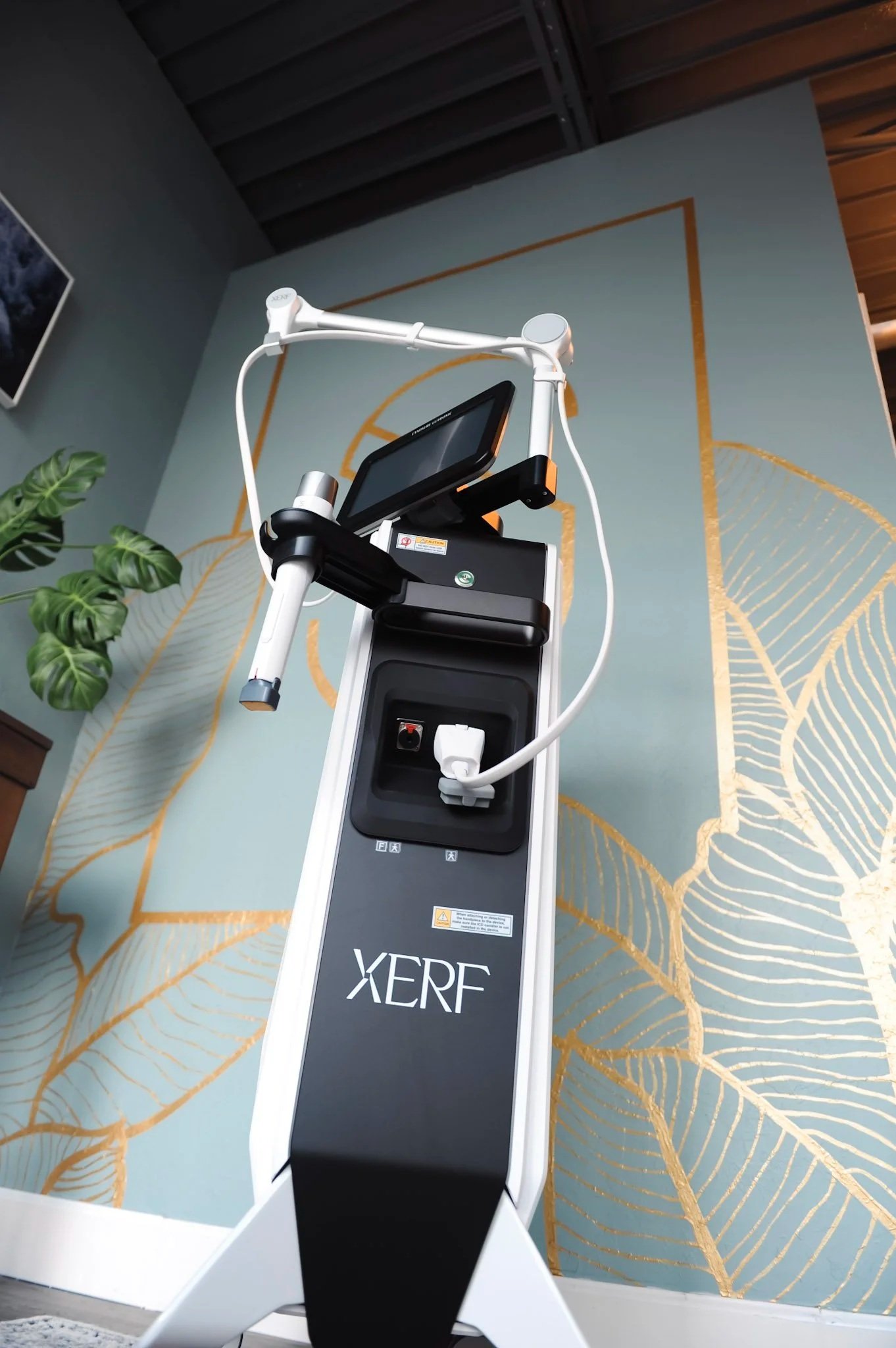 XERF, a non-invasive skin tightening machine against the spindrift aesthetic brand wall