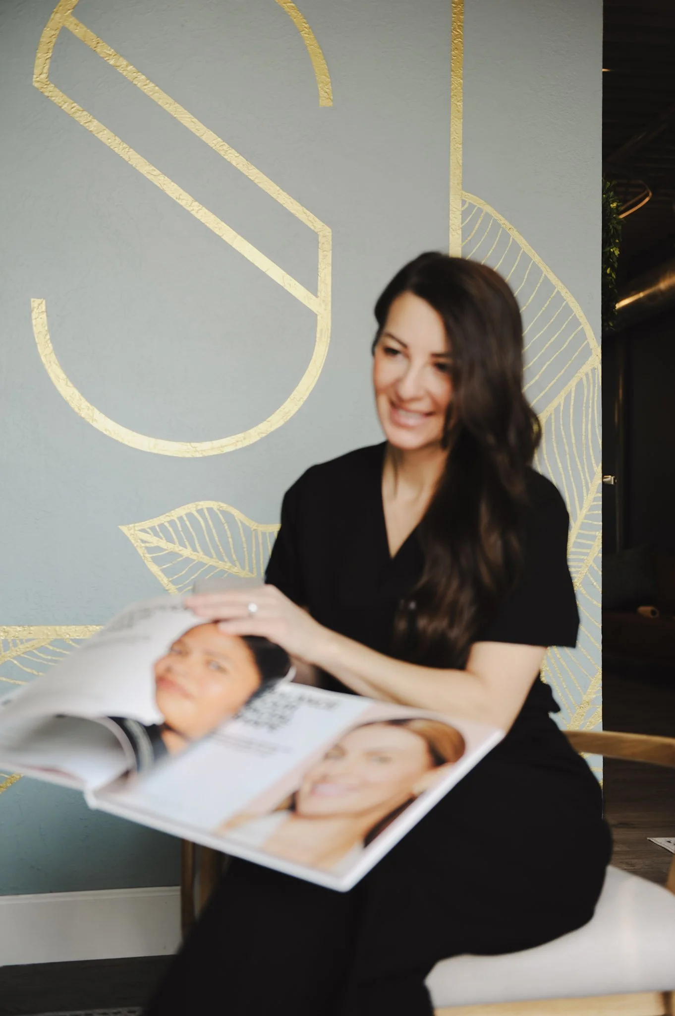 valerie prietz aprn holding a book during a consultation