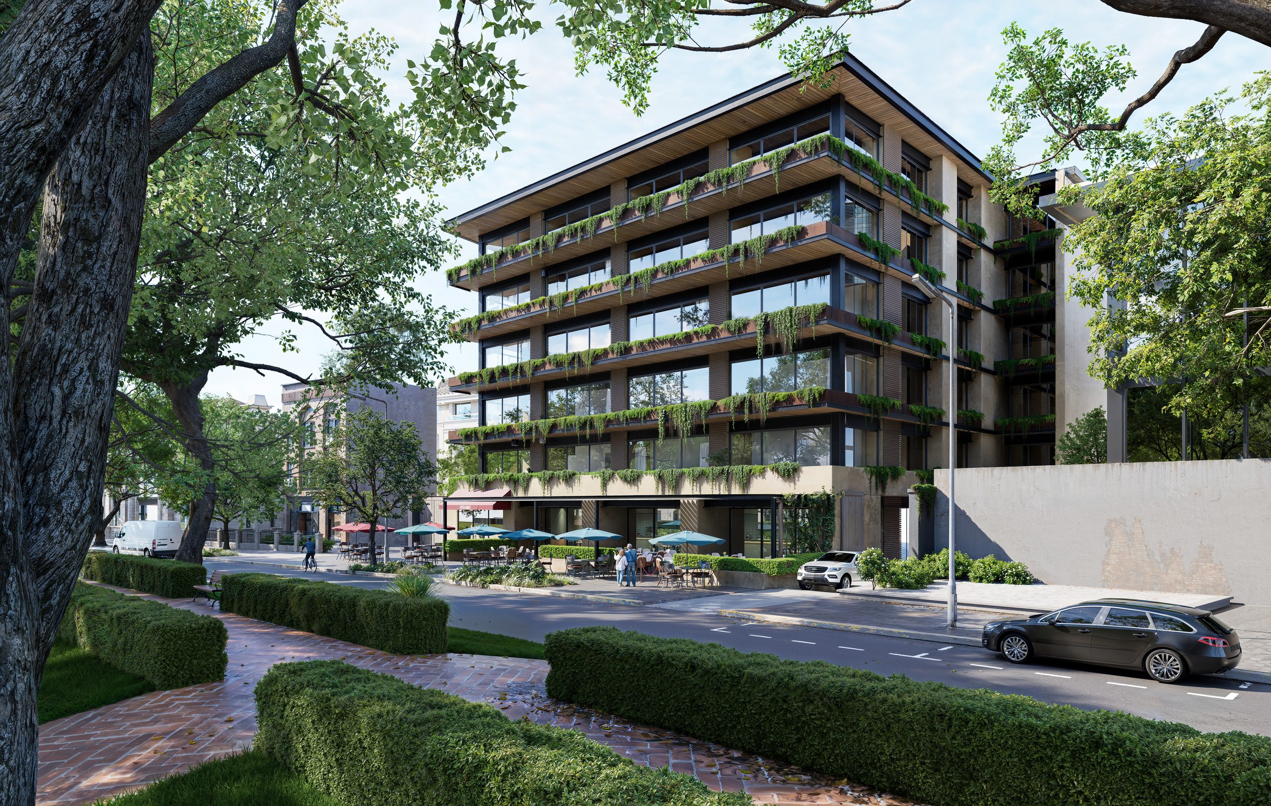 Edificio moderno de varios pisos con balcones con plantas colgantes, en una calle con árboles y área peatonal con cafe y personas.