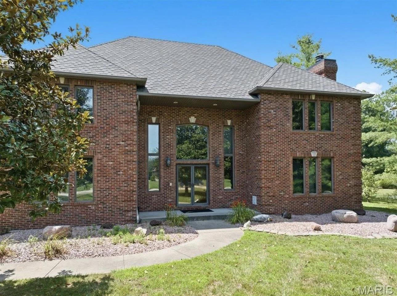 Two-story brick home in Shiloh Illinois with landscaped yard and front entry