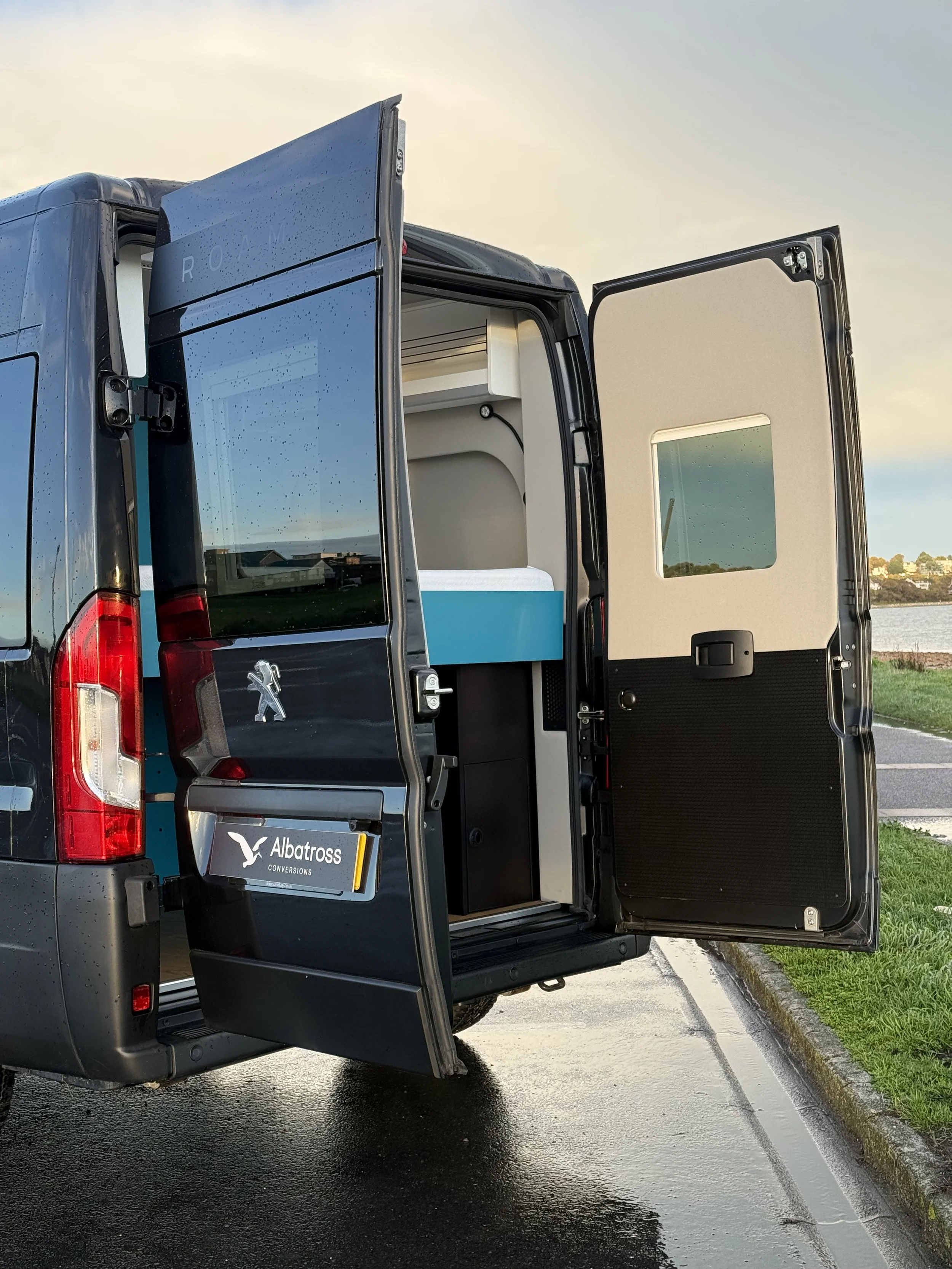 Back of the Peugeot Boxer van showing the rear fixed bed and garage area