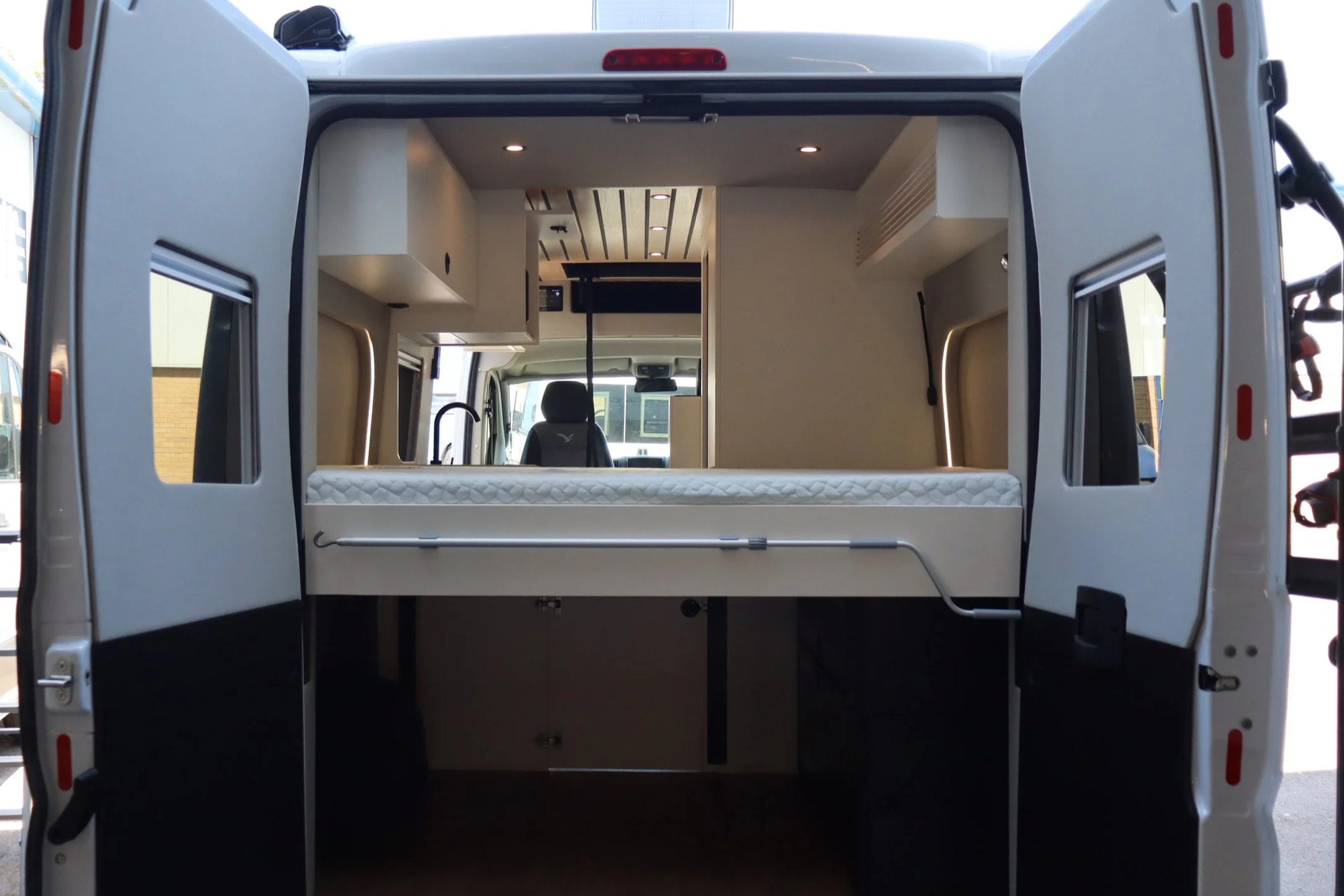 Back of the Peugeot Boxer van showing the rear fixed bed and garage area