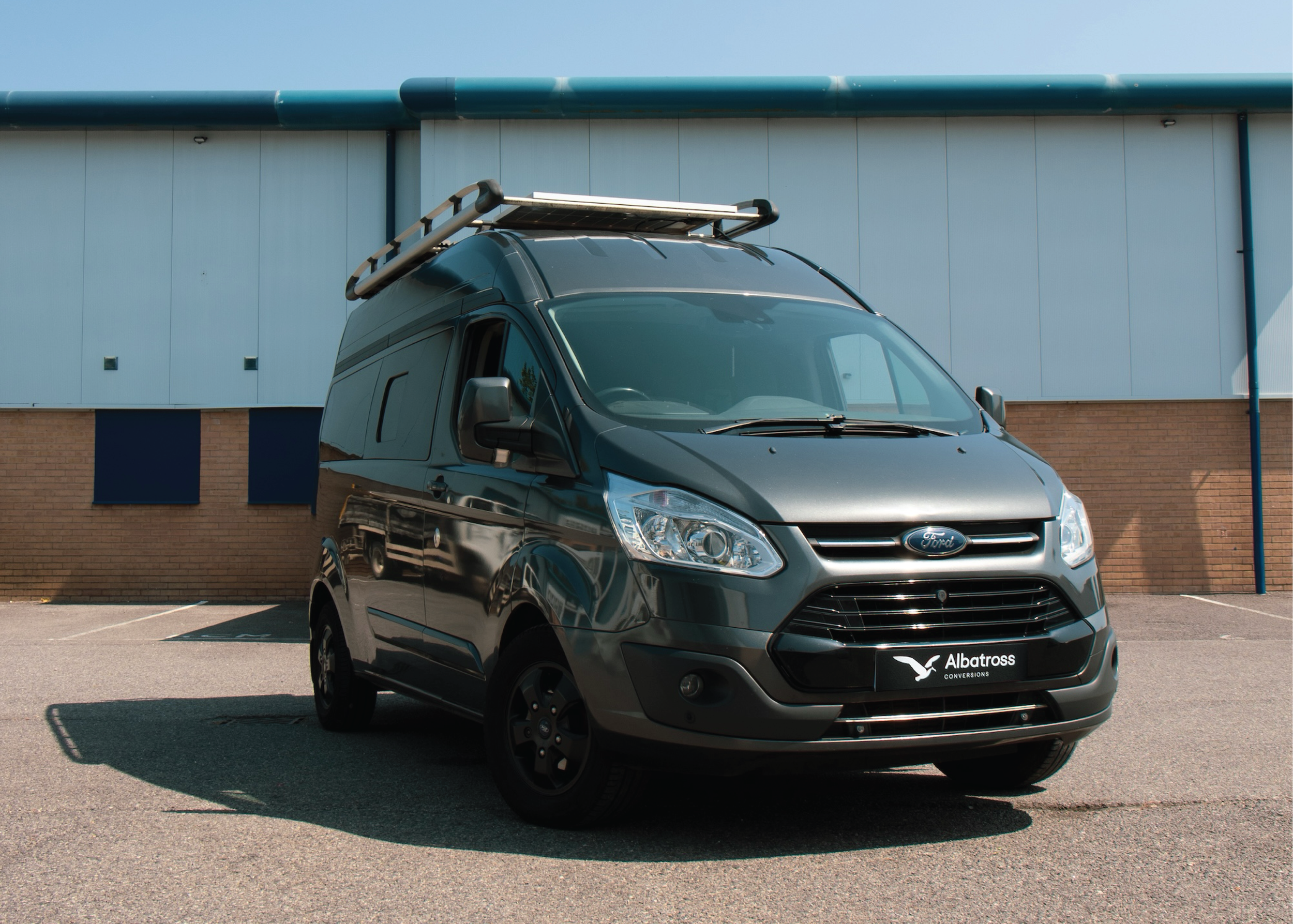 Grey Albatross Conversions Ford Transit Custom campervan parked outside our workshop in Poole, Dorset.