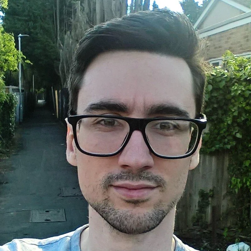 Colour selfie photo of a man with glasses.