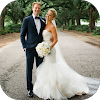 A bride and groom standing on a tree-lined street, holding hands and smiling.
