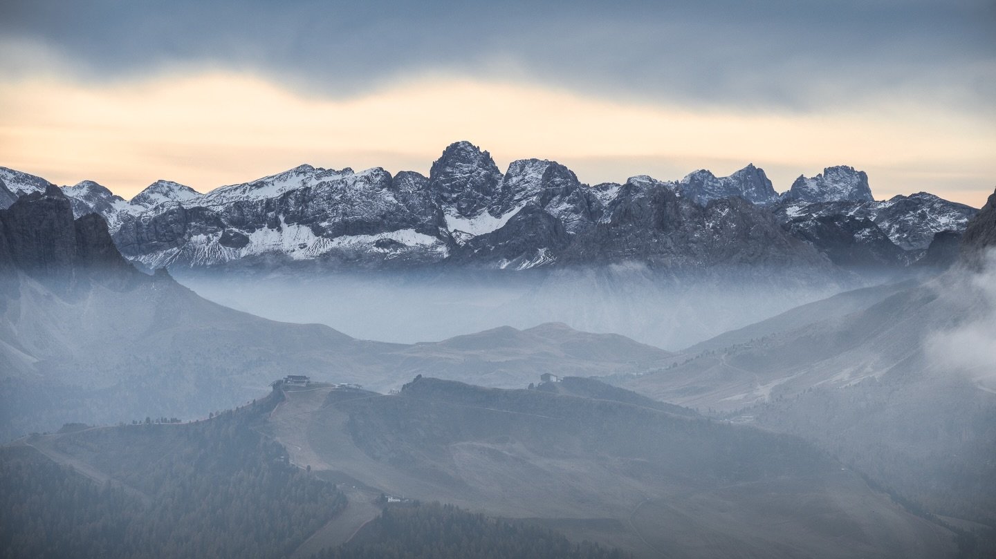 I captured this scene just after sunrise, when the light was soft and the mist settled in the valleys. The snow-covered peaks provided a strong backdrop, while the rolling hills in the foreground added depth to the composition. The muted colors and c