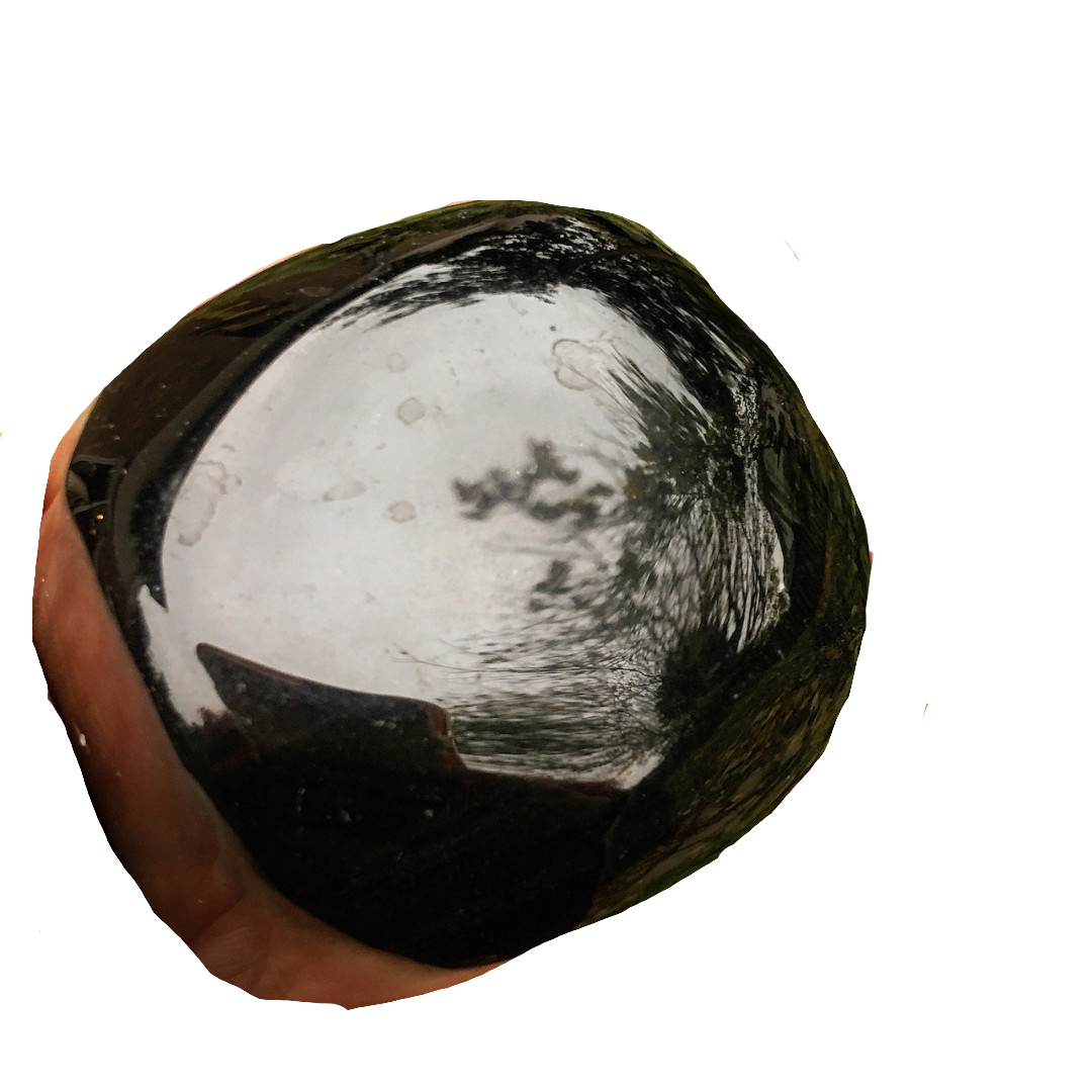 a polished palm stone of black obsidian