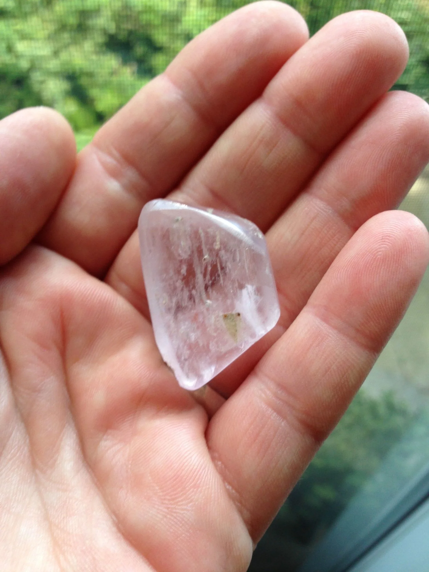 Krista holding a tumbled pink kunzite in her palm
