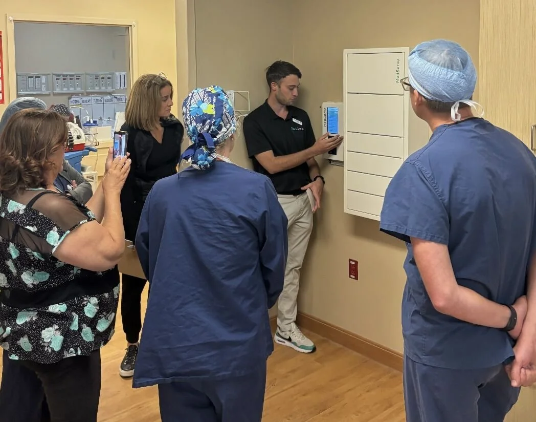 A MedServe team member training four ASC staff members on a Flex cabinet he just installed.