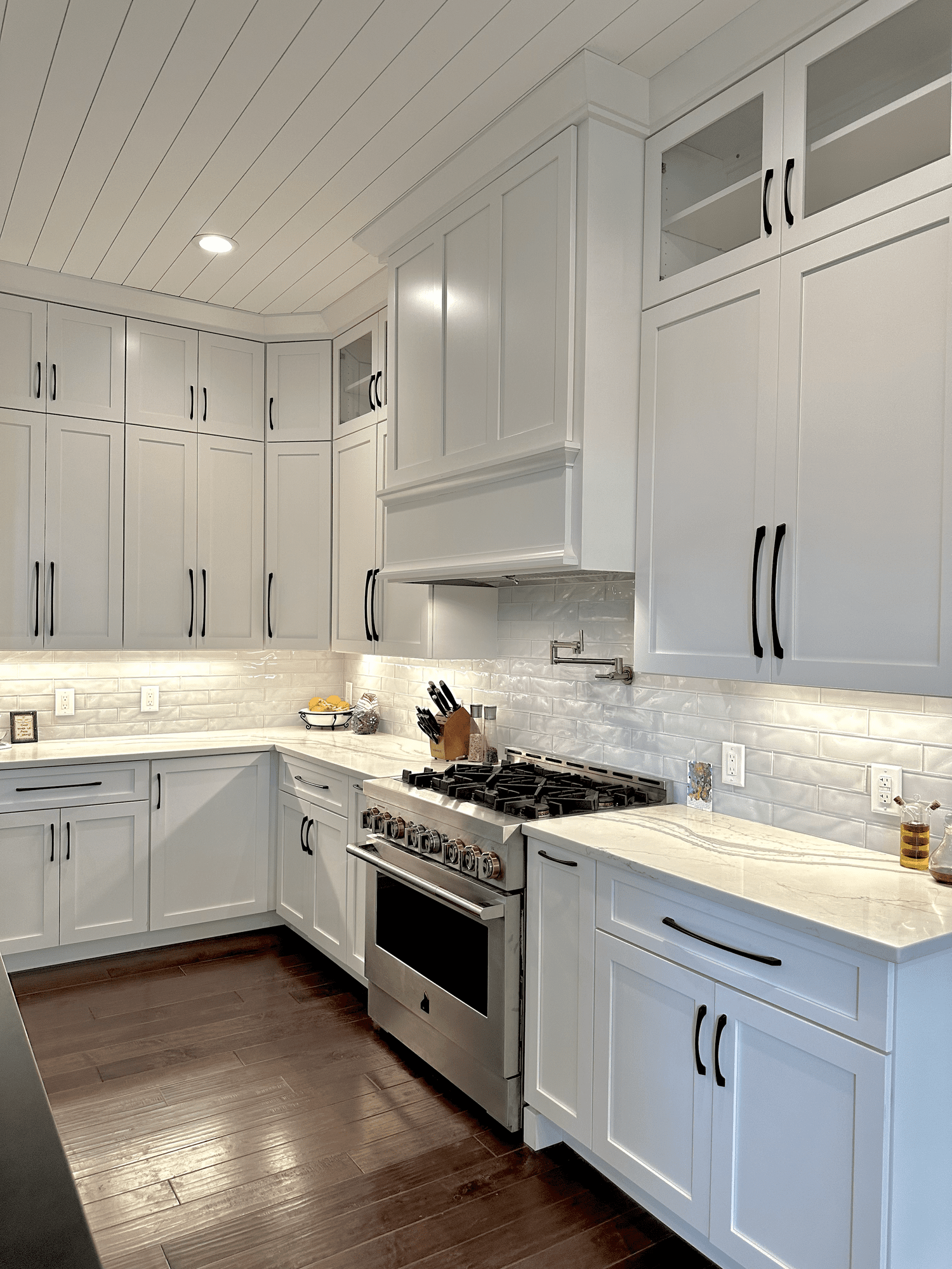White perimeter cabinets with light stone counters