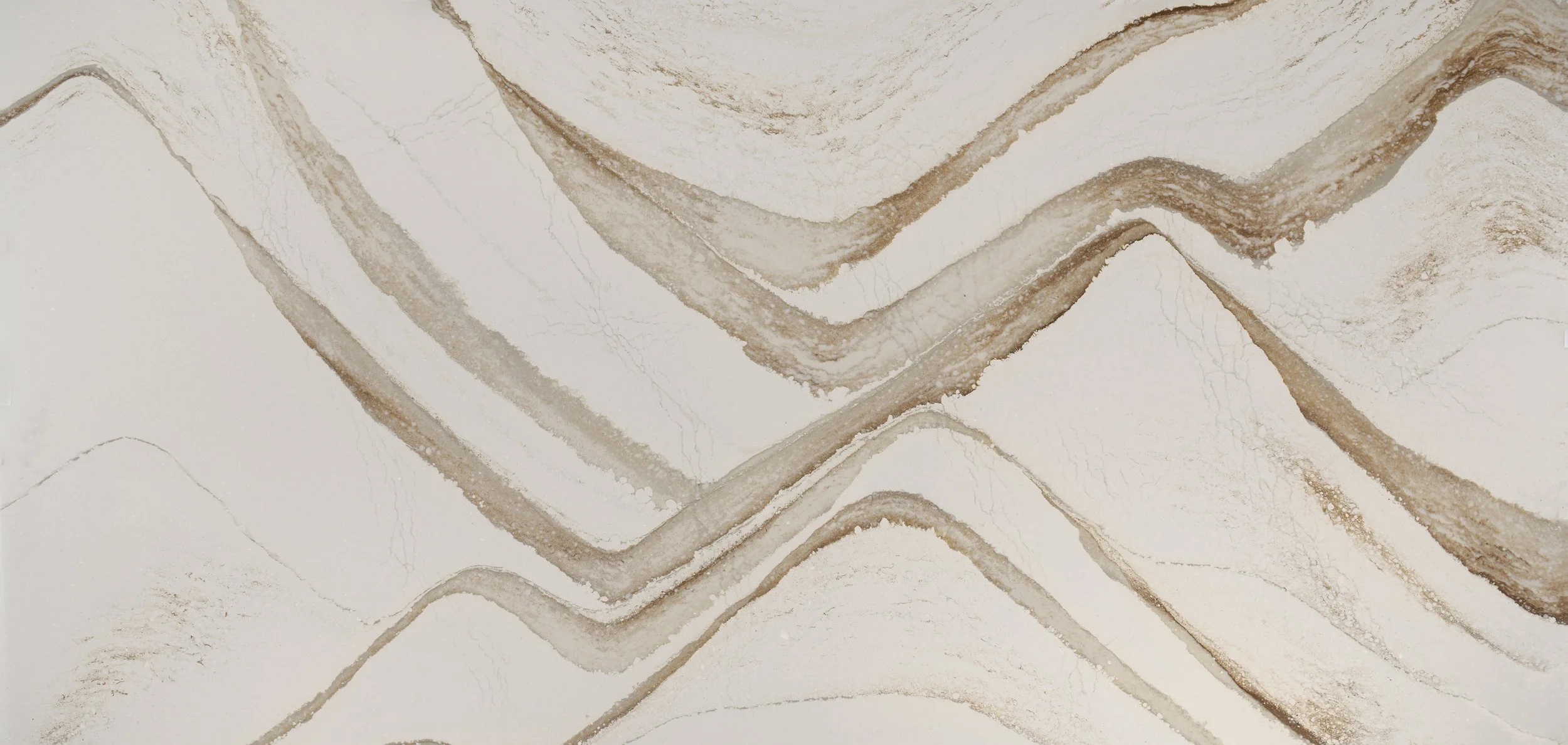 Brittanicca Gold Warm quartz slab pattern with broad gold and brown movement across a light background